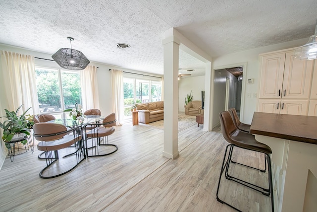 813 Crockett Dr, Columbus, GA 31904 - dining room with a textured ceiling and light wood-style flooring