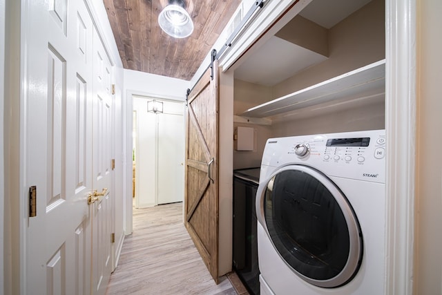 813 Crockett Dr, Columbus, GA 31904 - laundry area with washer / dryer, a barn door, and light wood-style flooring