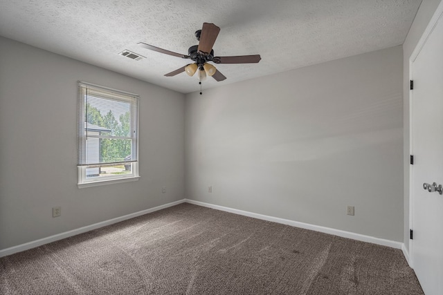 carpeted spare room with a ceiling fan, visible vents, and baseboards