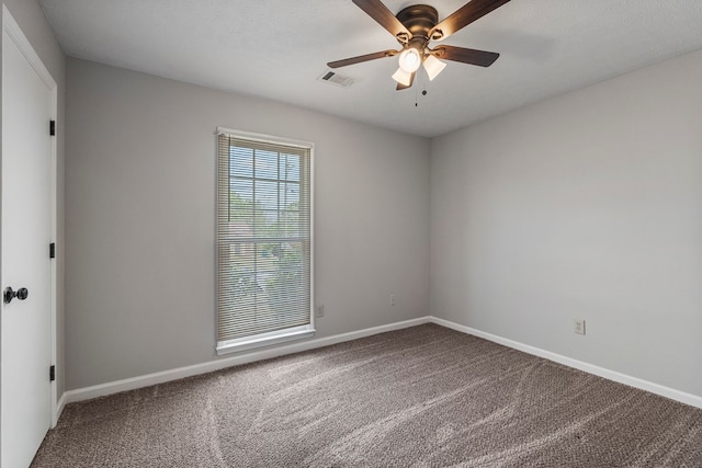 unfurnished room with carpet, visible vents, ceiling fan, and baseboards