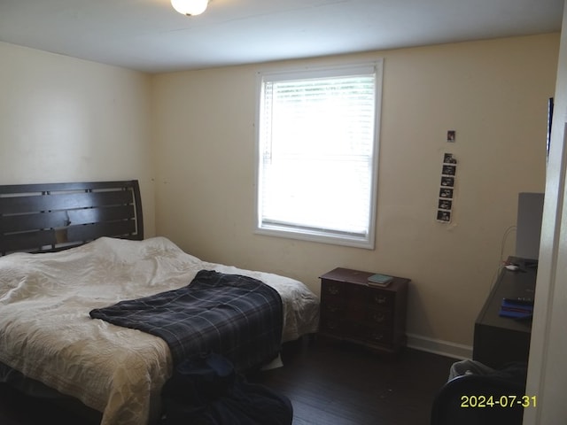 bedroom with dark hardwood / wood-style floors