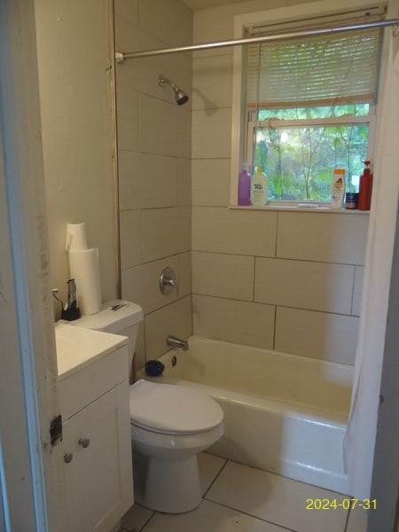 full bathroom featuring tile patterned floors, toilet, vanity, and tiled shower / bath