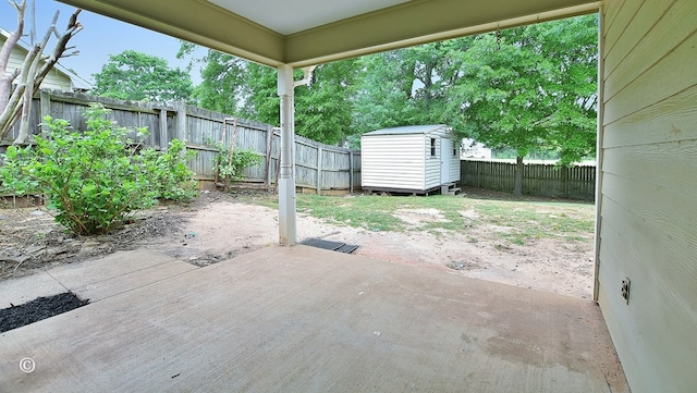 84 Summerbrook Loop, Smiths Station, AL 36870 - view of patio / terrace with a storage unit, a fenced backyard, and an outbuilding