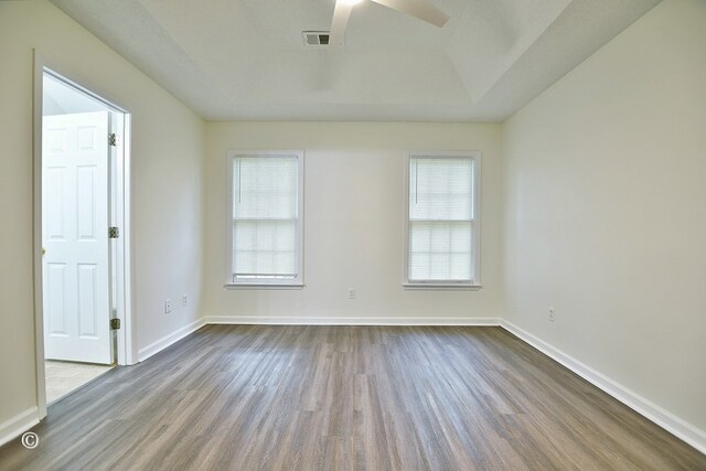84 Summerbrook Loop, Smiths Station, AL 36870 - empty room featuring a ceiling fan, baseboards, visible vents, and dark wood-style floors