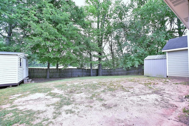 84 Summerbrook Loop, Smiths Station, AL 36870 - view of yard featuring a storage shed, an outdoor structure, and a fenced backyard