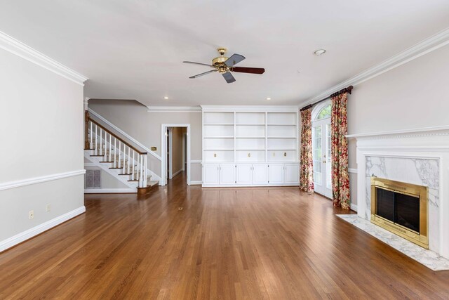 5110 Midland Trce, Columbus, GA 31820 - unfurnished living room with ceiling fan, stairs, wood finished floors, a premium fireplace, and crown molding