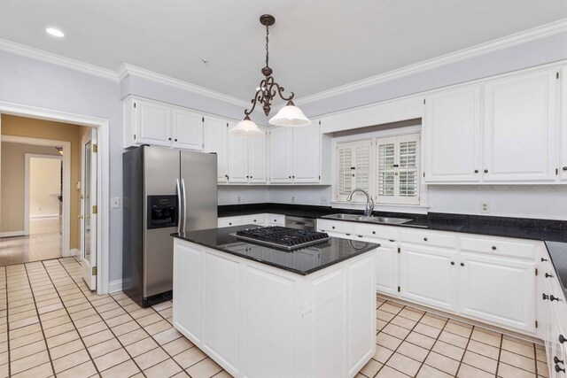 5110 Midland Trce, Columbus, GA 31820 - kitchen with stainless steel appliances, white cabinets, light tile patterned flooring, a kitchen island, and crown molding
