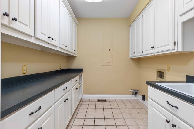 5110 Midland Trce, Columbus, GA 31820 - laundry room with washer hookup, cabinet space, electric panel, and light tile patterned flooring