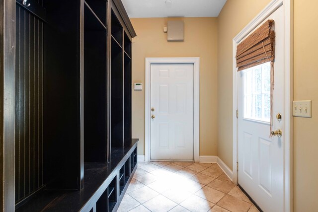 5110 Midland Trce, Columbus, GA 31820 - kitchen with light wood-type flooring, crown molding, glass insert cabinets, light stone countertops, and brown cabinetry
