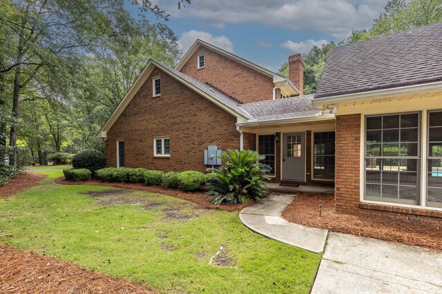 5110 Midland Trce, Columbus, GA 31820 - view of front of property featuring brick siding, a front yard, a chimney, and a shingled roof