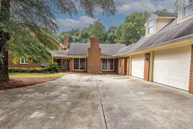 5110 Midland Trce, Columbus, GA 31820 - view of front of house featuring brick siding, driveway, a garage, a chimney, and roof with shingles