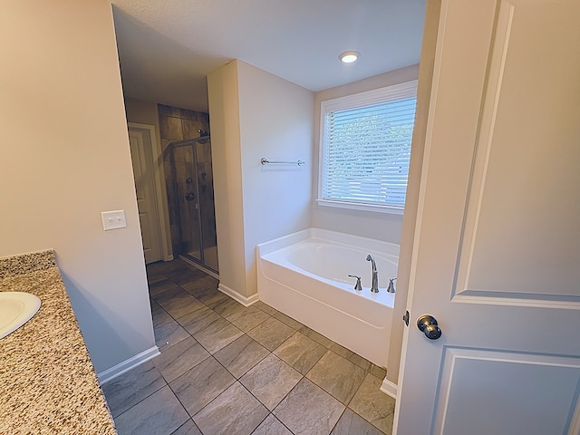 8840 Sullivans Dr, Midland, GA 31820 - bathroom featuring a garden tub, a shower stall, vanity, and baseboards