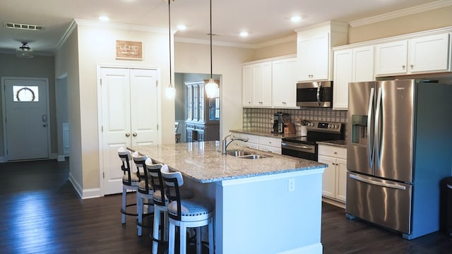 8840 Sullivans Dr, Midland, GA 31820 - kitchen featuring stainless steel appliances, a sink, dark wood-type flooring, an island with sink, and white cabinets