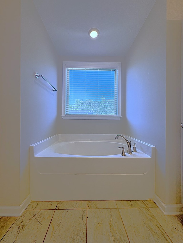 8840 Sullivans Dr, Midland, GA 31820 - full bathroom with a bath, baseboards, and marble look tile flooring