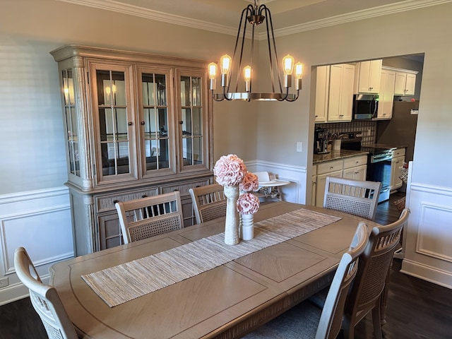 8840 Sullivans Dr, Midland, GA 31820 - dining room with a chandelier, ornamental molding, dark wood-style floors, wainscoting, and a decorative wall
