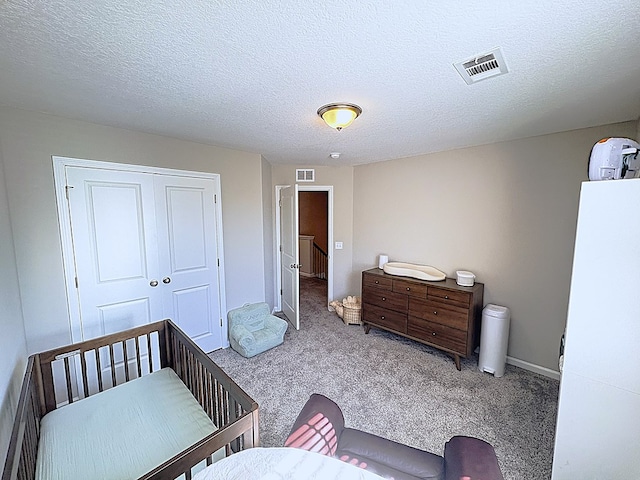 8840 Sullivans Dr, Midland, GA 31820 - bedroom featuring carpet floors, a textured ceiling, and a closet