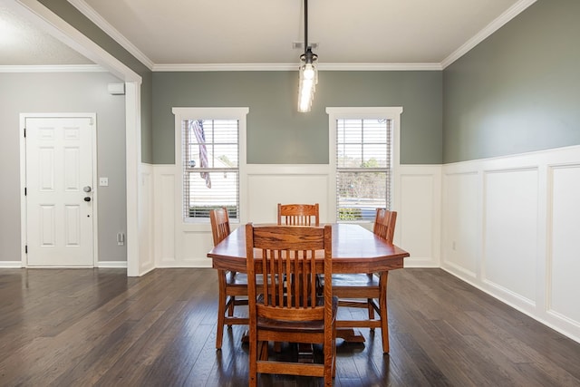 dining space with dark wood-type flooring, ornamental molding, and plenty of natural light