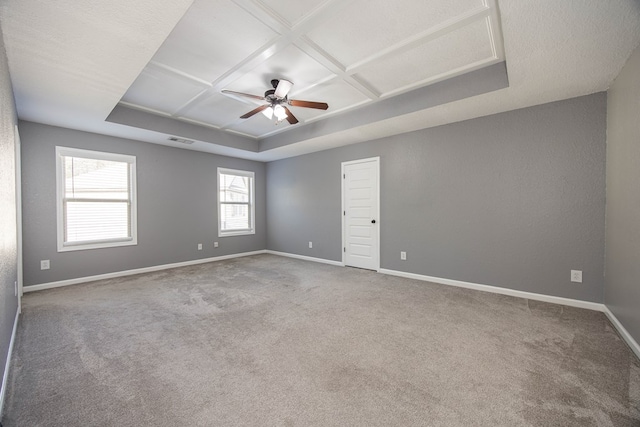 carpeted spare room featuring beamed ceiling, coffered ceiling, and ceiling fan