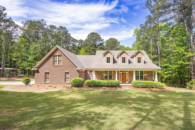 3450 Mckee Rd, Upatoi, GA 31829 - cape cod home featuring brick siding, a porch, and a front yard