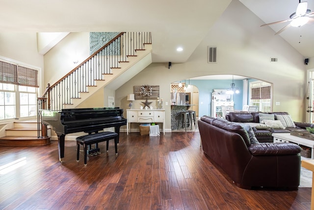 3450 Mckee Rd, Upatoi, GA 31829 - living area with arched walkways, high vaulted ceiling, ceiling fan, stairway, and dark wood-type flooring