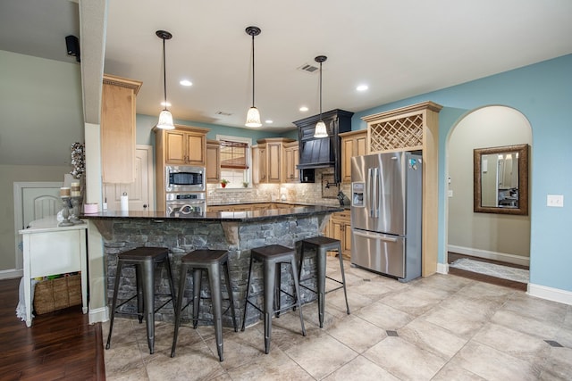 3450 Mckee Rd, Upatoi, GA 31829 - kitchen featuring stainless steel appliances, a peninsula, tasteful backsplash, a breakfast bar, and dark stone countertops