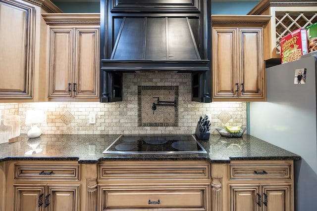 3450 Mckee Rd, Upatoi, GA 31829 - kitchen featuring freestanding refrigerator, extractor fan, black electric stovetop, and decorative backsplash