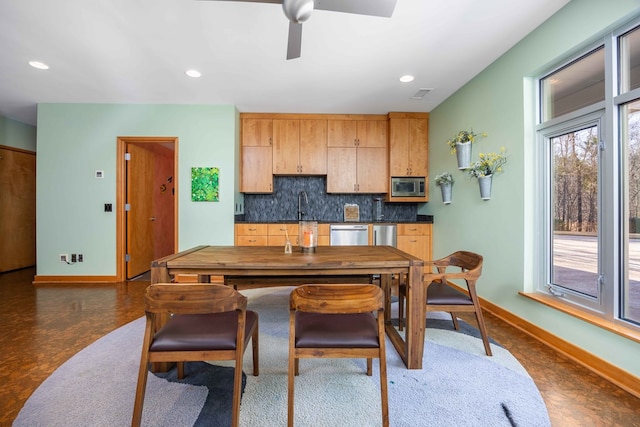 kitchen featuring backsplash, ceiling fan, sink, and stainless steel appliances