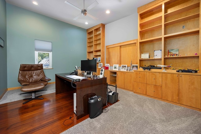 office featuring ceiling fan and dark carpet