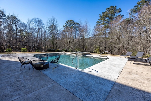 view of pool with a diving board, an in ground hot tub, and a patio