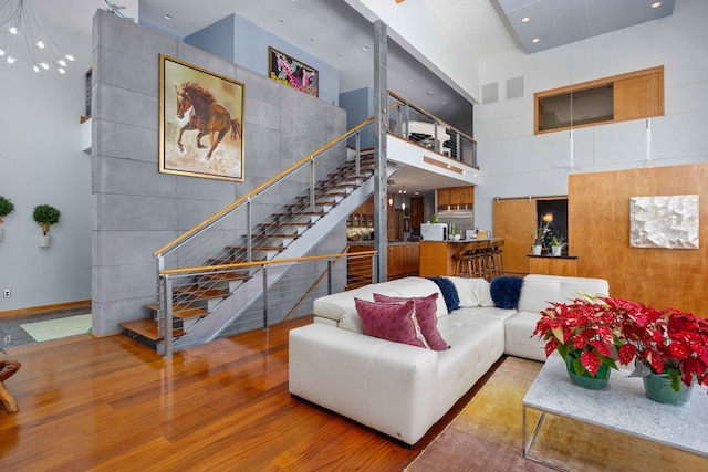 living room with hardwood / wood-style floors and a high ceiling