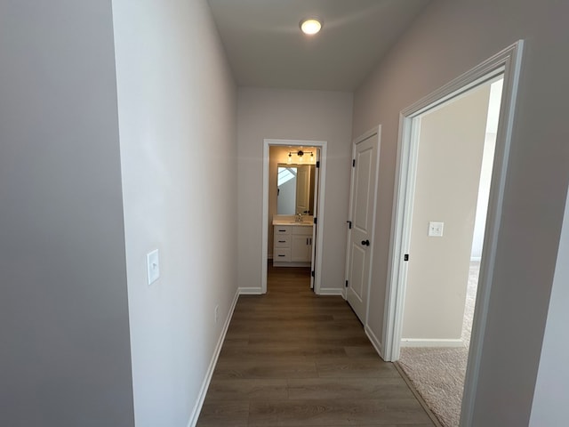 corridor featuring hardwood / wood-style flooring and sink