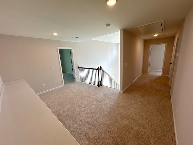 unfurnished room featuring light colored carpet