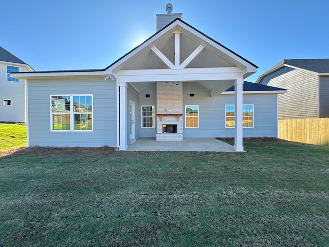 back of property featuring a patio area and a lawn