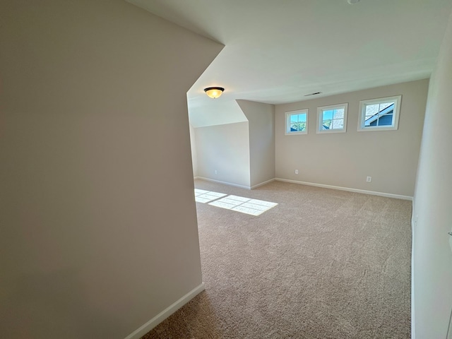 additional living space with light colored carpet