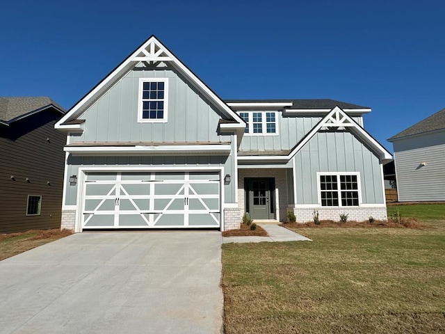 craftsman-style home featuring a garage and a front yard