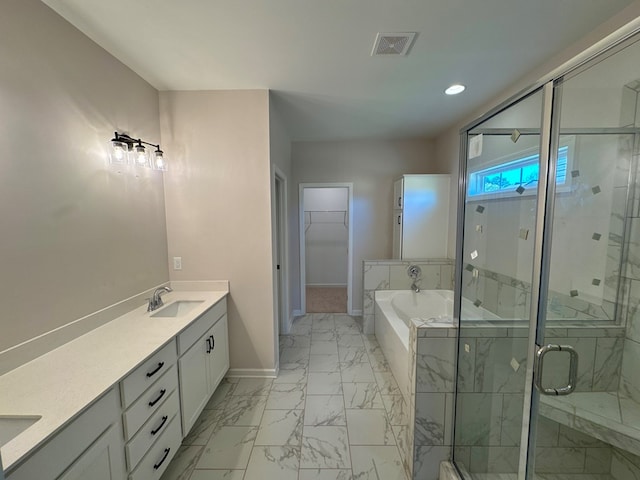 bathroom featuring shower with separate bathtub and vanity