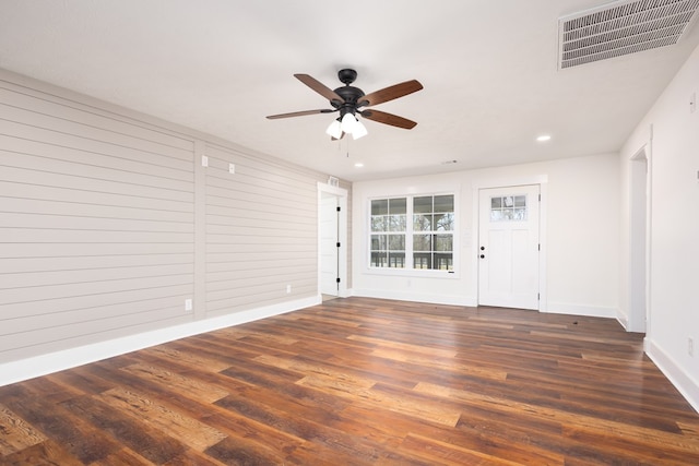 empty room featuring dark wood finished floors, recessed lighting, visible vents, a ceiling fan, and baseboards