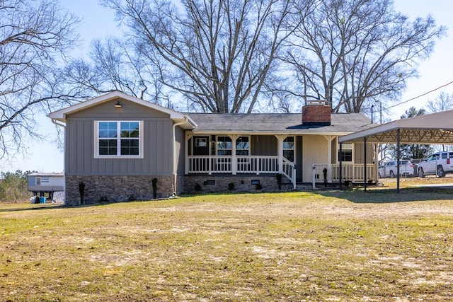 ranch-style home featuring a chimney, a front lawn, a porch, and board and batten siding