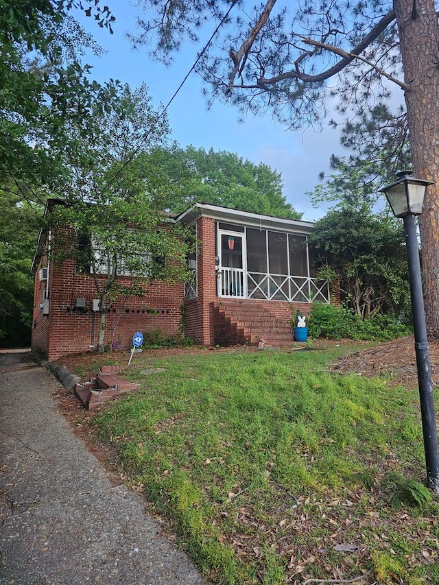 view of outbuilding featuring a sunroom