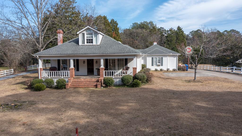 1011 Bass Rd, Macon, GA 31210 - view of front of home featuring fence, a porch, roof with shingles, a chimney, and driveway