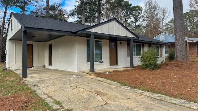 view of front of property with a porch and a carport