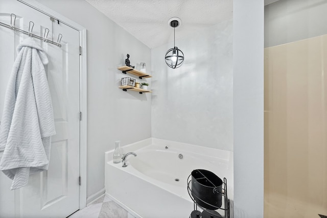 4607 N Tillery Dr, Phenix City, AL 36870 - bathroom featuring a bath, a textured ceiling, and marble finish flooring