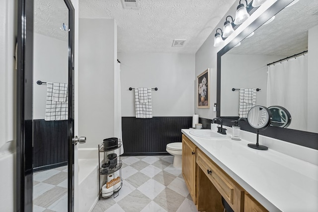 4607 N Tillery Dr, Phenix City, AL 36870 - full bathroom with vanity, a textured ceiling, curtained shower, a wainscoted wall, and a bath