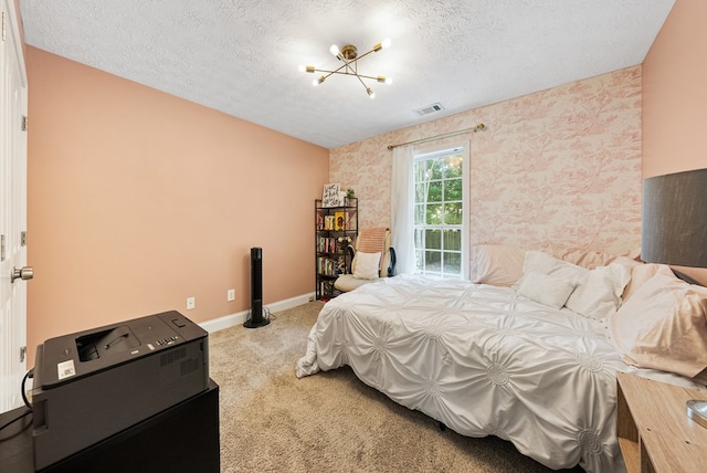 4607 N Tillery Dr, Phenix City, AL 36870 - carpeted bedroom featuring wallpapered walls, a chandelier, and a textured ceiling