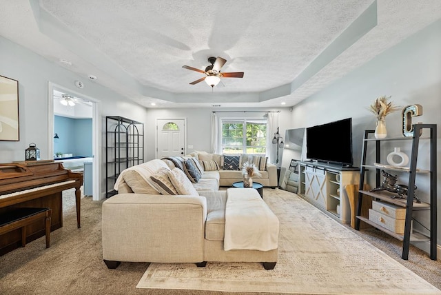 4607 N Tillery Dr, Phenix City, AL 36870 - carpeted living area with ceiling fan, a textured ceiling, and a tray ceiling
