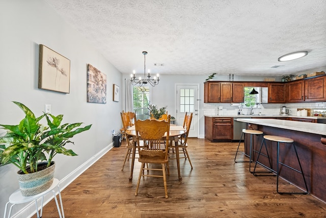 4607 N Tillery Dr, Phenix City, AL 36870 - dining room with dark wood finished floors, a textured ceiling, and a chandelier