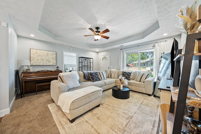 4607 N Tillery Dr, Phenix City, AL 36870 - living room with a raised ceiling, a textured ceiling, a ceiling fan, and light carpet