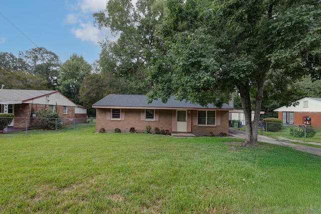 single story home featuring a front lawn