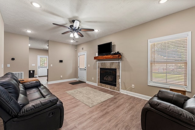 344 Lee Road 2040, Phenix City, AL 36870 - living room with a tiled fireplace, ceiling fan, light wood finished floors, and recessed lighting