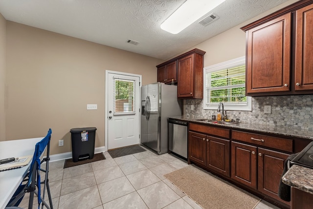344 Lee Road 2040, Phenix City, AL 36870 - kitchen with stainless steel appliances, decorative backsplash, dark stone counters, and light tile patterned flooring
